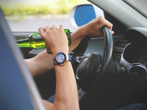 guy drinking beer in car