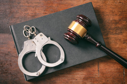 handcuffs gavel arrested crime