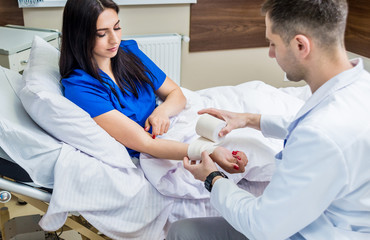 woman in hospital bed with doctor