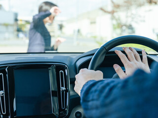 person honking while pedestrian crosses