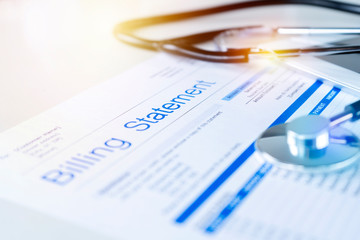 stethoscope and medical billing paperwork