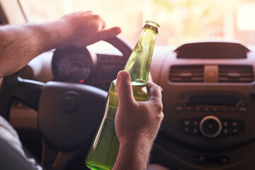holding beer while driving car