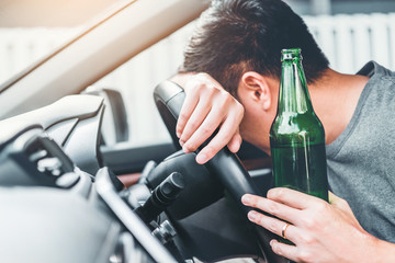guy with beer drunk driving