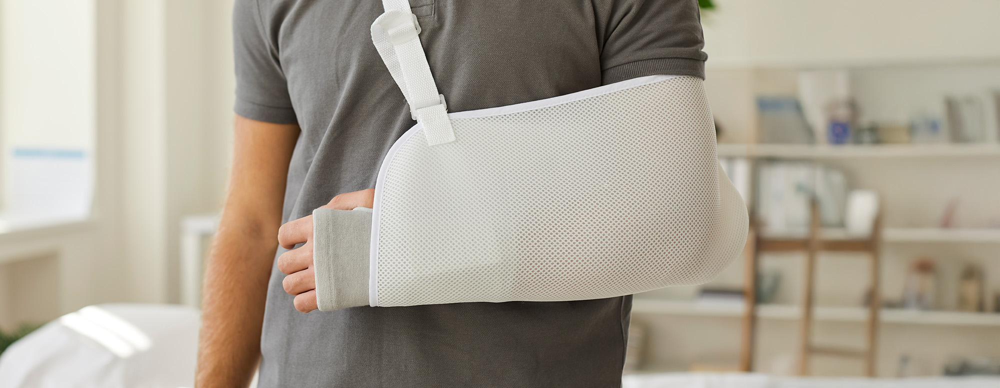 Man wear sling bandage on broken hand