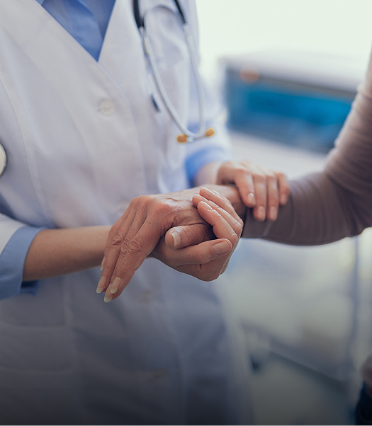Close-up of doctor taking mature woman by arm